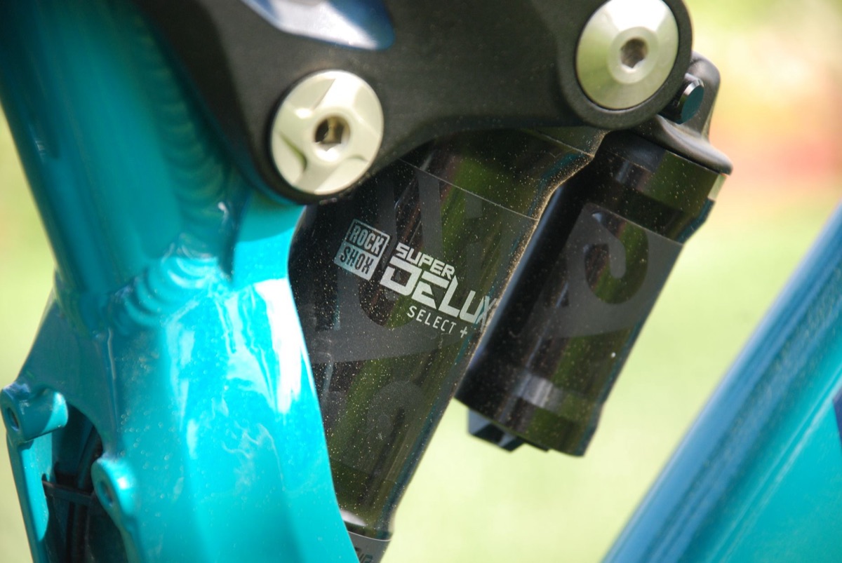 Close-up of a RockShox Super Deluxe air rear shock mounted in a full-suspension frame linkage.