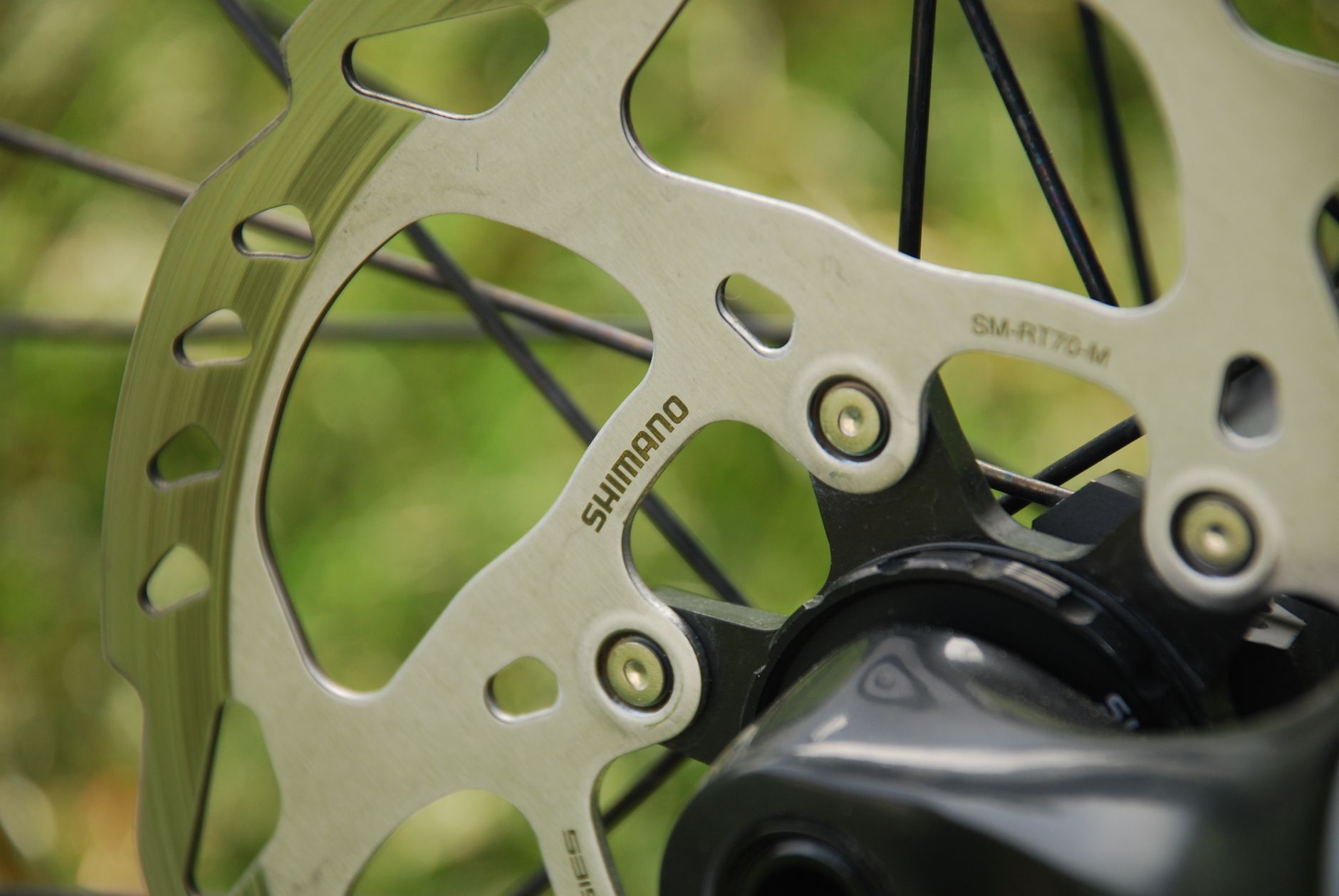 Close-up of a Shimano SM-RT70 Centerlock disc rotor on a mountain bike hub.