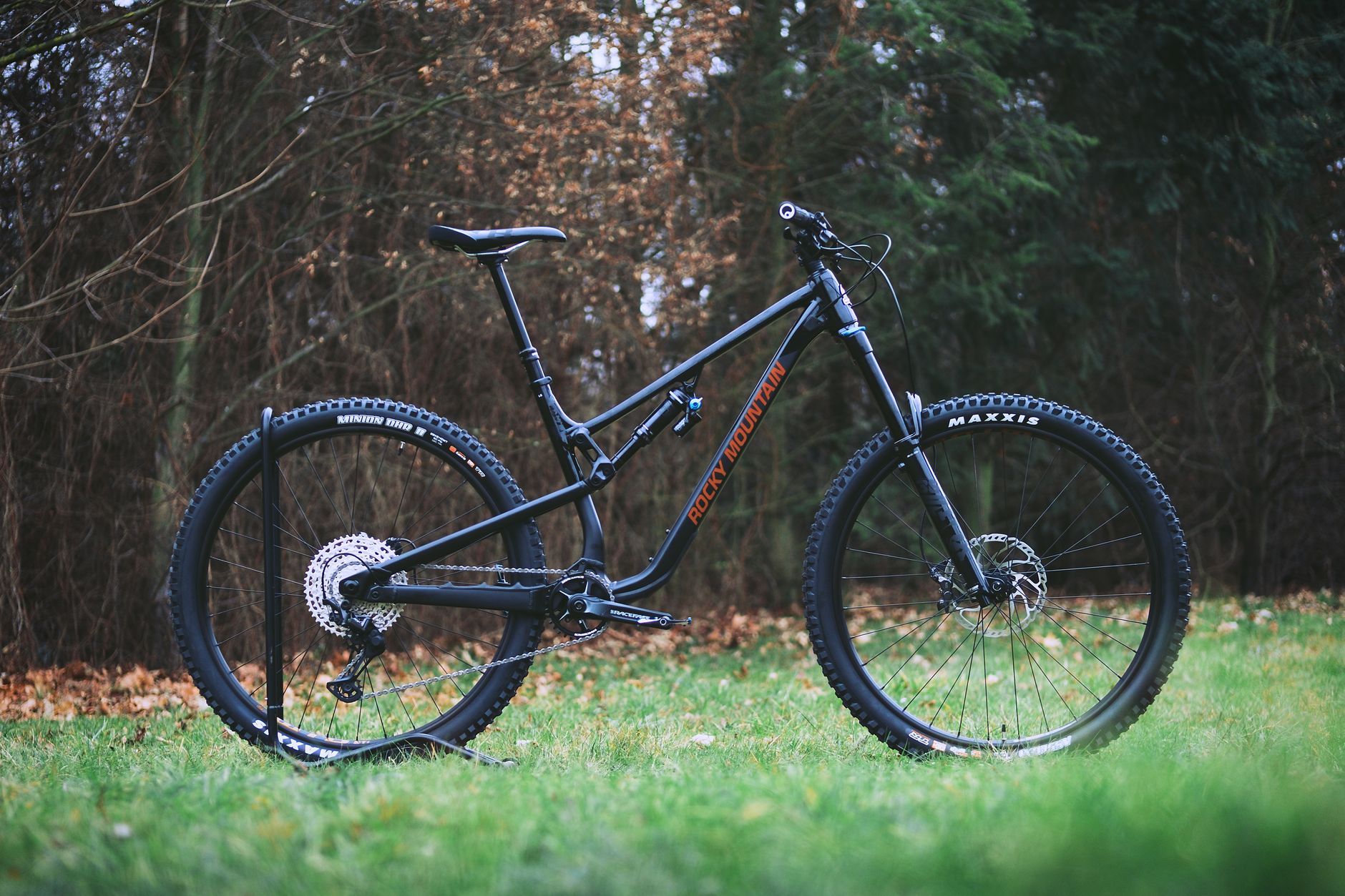 Side profile of a Rocky Mountain full-suspension trail bike showing its sloping top tube and seatpost extension.